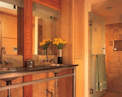 The aesthetic of the master bathroom, outfitted with dual basins and exposed metal pipe, centers on light and reflection and a clean balance between function and form.